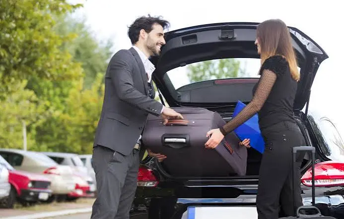 Chauffeur service NYC driver loading bags before a pickup