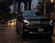Luxury car service NYC driver opening the door for a passenger