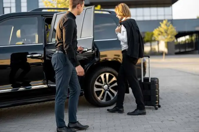 Manhattan car service driver holding a name sign at airport arrivals